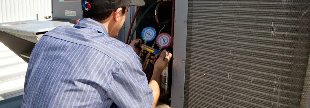 HVAC technician servicing a condenser unit in Palmer Ranch